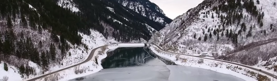 drone video ice skater on frozen lake utah